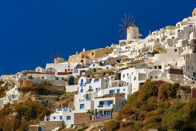Moulins à vent et maisons blanches à Oia ou Ia sur l'île de Santorin, Grèce