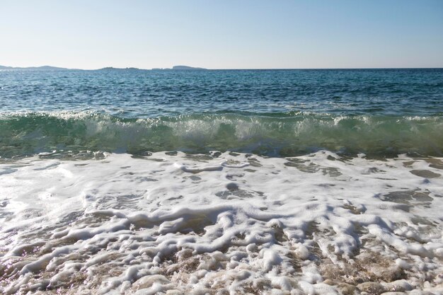 Photo la mousse de mer et les vagues sur la plage