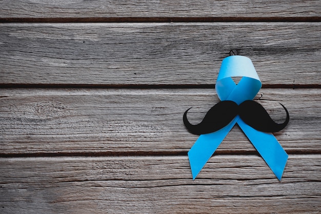 moustache avec ruban bleu sur bois.