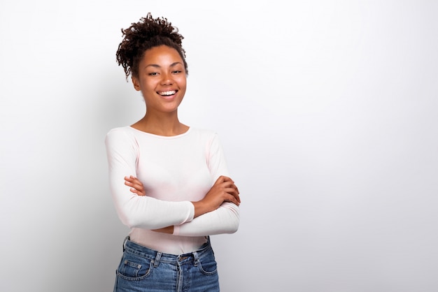 Mulâtre fille heureuse a plié ses mains debout