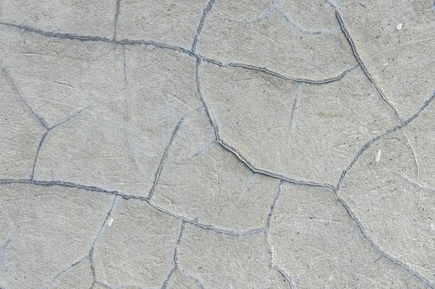 Un mur de béton fissuré en blanc