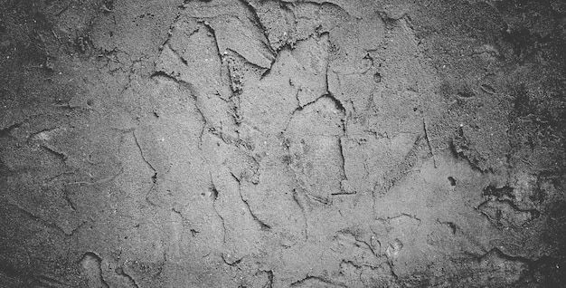 Mur de béton noir ou fond de texture de pierre granuleuse rugueuse gris foncé