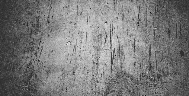 Mur de béton noir ou fond de texture de pierre granuleuse rugueuse gris foncé