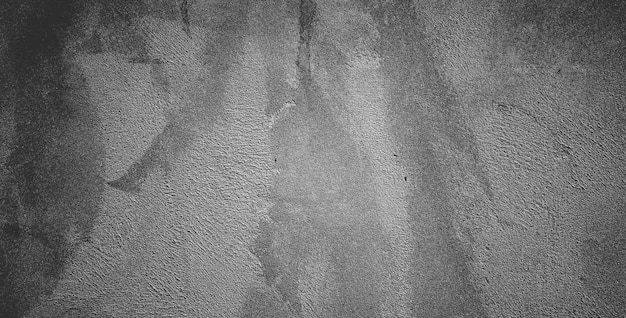 Mur de béton noir ou fond de texture de pierre granuleuse rugueuse gris foncé