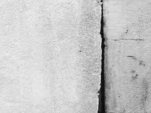 Mur de béton patiné et sale fond de texture en noir et blanc.