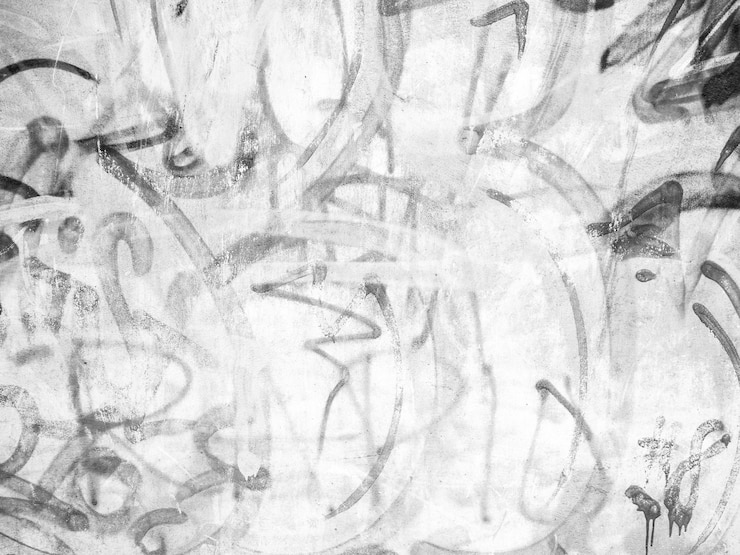Photo mur blanc avec graffitti noir