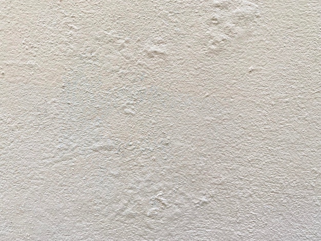 Photo un mur blanc avec une surface texturée rugueuse.