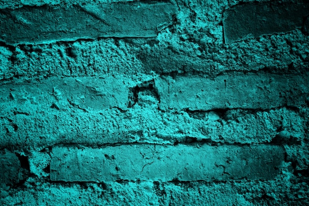 Un mur de briques bleues avec un fond de briques vertes