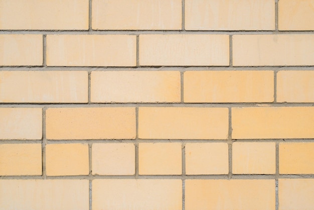 Mur de briques de briques jaune clair à l'extérieur agrandi Fond de texture de pierre de maçonnerie