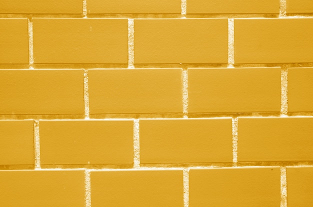 Mur de briques de couleur jaune vif pour le fond