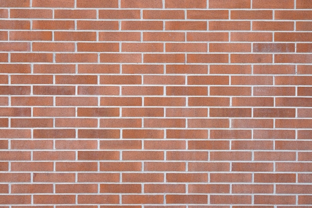Un mur de briques avec un fond de briques rouges