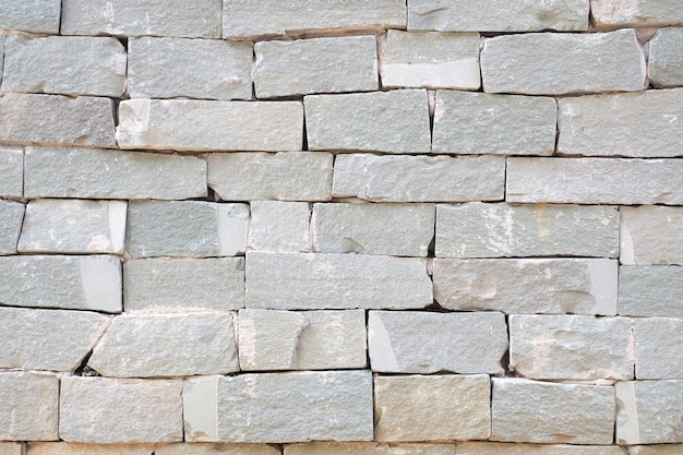 Mur de briques grises et fond de mur de pierre de sable rugueux