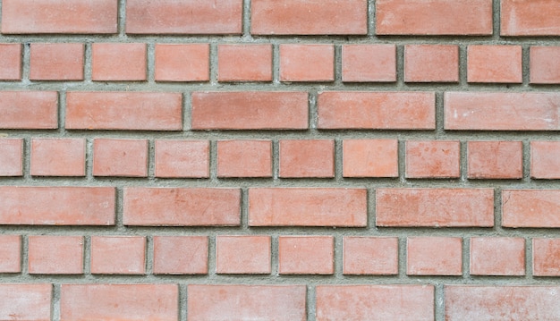 Mur de briques de pierre rouge gros plan