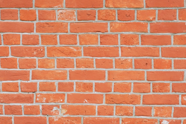 Mur de briques rouges proche perspective. Gros plan photo verticale de fond rousse