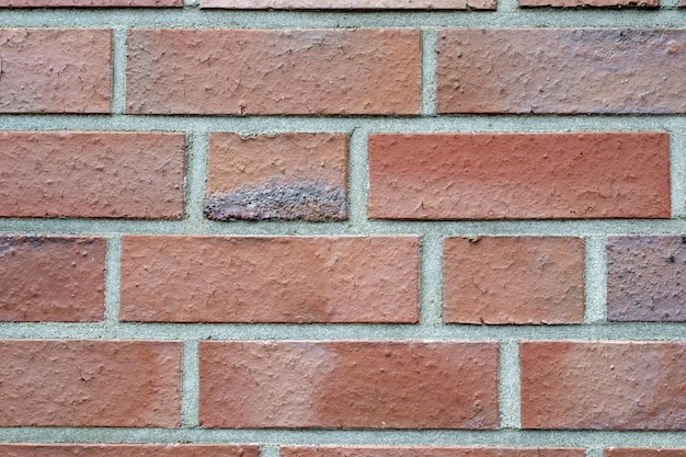 Un mur de briques avec une tache sombre Structure du mur de briques vintage Photo de haute qualité