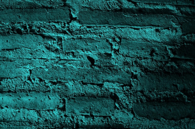 Un mur de briques vertes avec un fond de briques bleues.