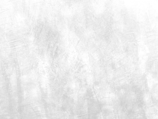 Le mur de ciment de couleur claire a des fissures