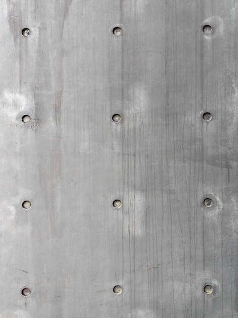 Photo mur de ciment gris avec rivets fond de texture vintage