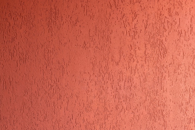 mur avec façade de maison décorative en plâtre rouge avec structure technique à la spatule