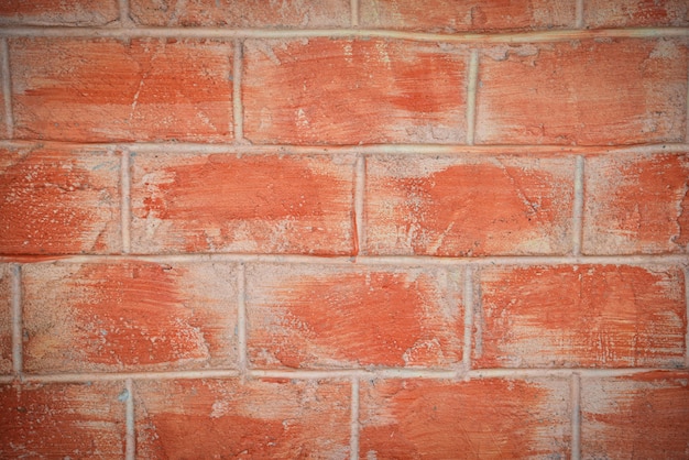 Mur de modèle de brique rouge ou orange avec du plâtre de béton de ciment pour la texture