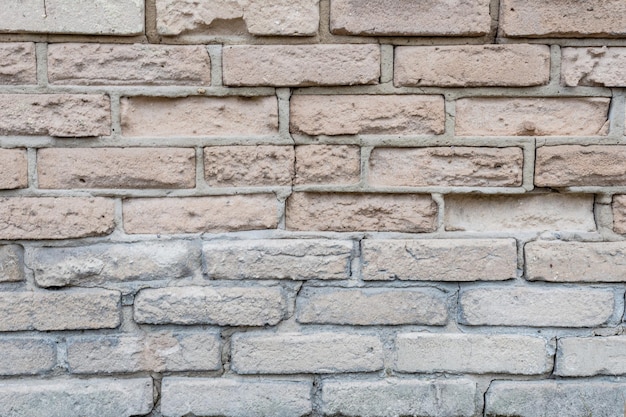 Mur de pierre découpant le vieux modèle de brique blanche fond