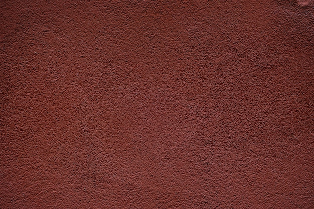 Mur de plâtre rouge foncé