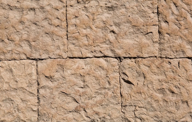 Murs de maçonnerie de couleur sable naturel Texture de pierre gros plan construction et fond minier