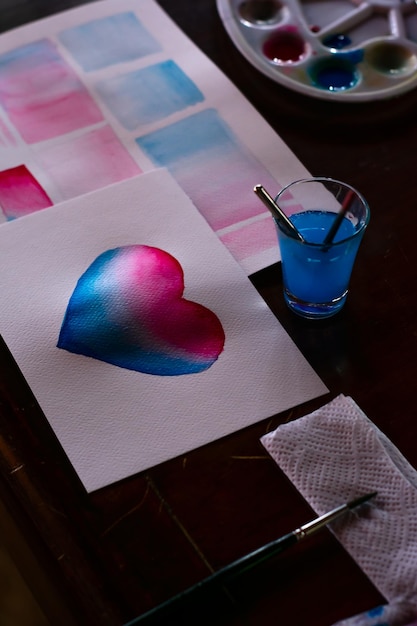 Photo nature morte d'éléments aquarelles pour peindre un coeur carte faite main romantique