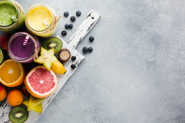 Photo nature morte pots de smoothie sur une planche