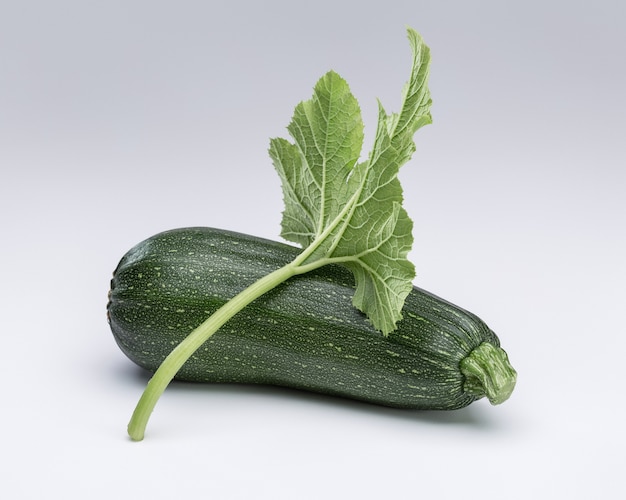 Nature morte de récolte d'été avec courge verte sur fond blanc.