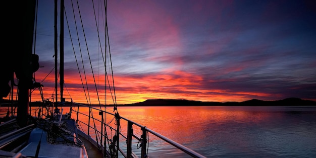 Navire nautique en mer contre le ciel au coucher du soleil