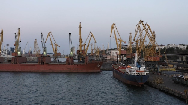 Navires-citernes et grues dans le paysage industriel du port d'odesa au ciel crépusculaire