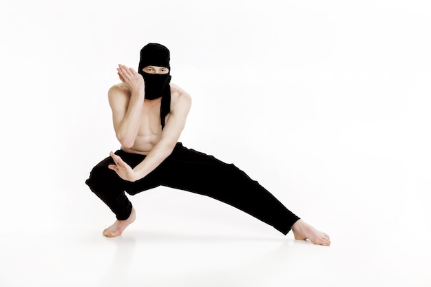 Ninja sur fond blanc combattant masculin en vêtements noirs
