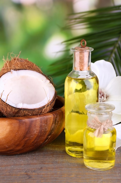 Noix de coco et huile de noix de coco sur une table en bois sur fond de nature