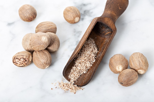 Noix de muscade et moulu sur fond de marbre blanc