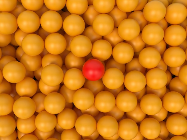 De nombreuses balles jaunes avec une balle rouge au centre