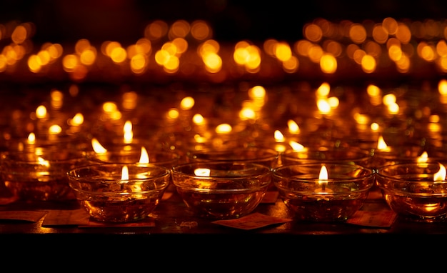 De nombreuses bougies allumées à faible profondeur de champ, bougies dans une église