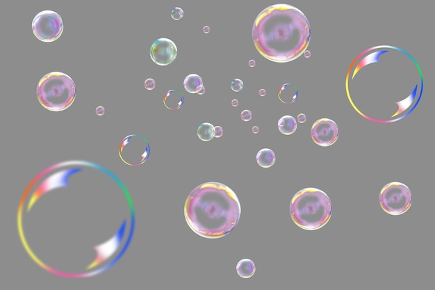 De nombreuses bulles de savon multicolores sur fond gris.