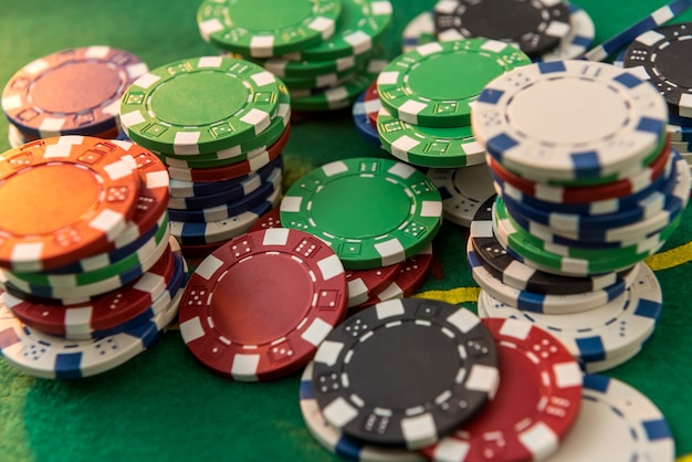 De nombreux jetons de poker à coût différent sur la table de jeu