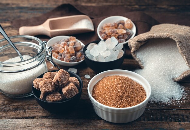 De nombreux types de sucre sur un fond en bois. Vue de côté.