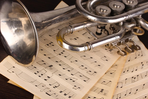 Photo notes de musique et trompette sur table en bois