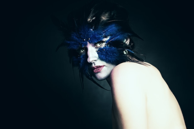 Notion de fantaisie. Femme avec le maquillage d'art. Oiseau bleu fantastique. Maquillage de scène