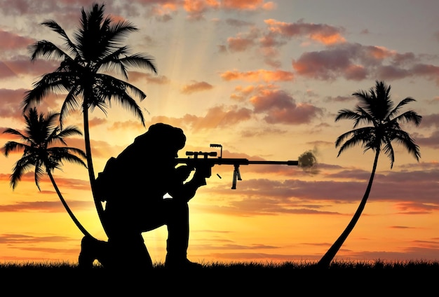 Notion de terrorisme. Silhouette d'un terroriste avec un fusil sur fond de coucher de soleil et de palmiers