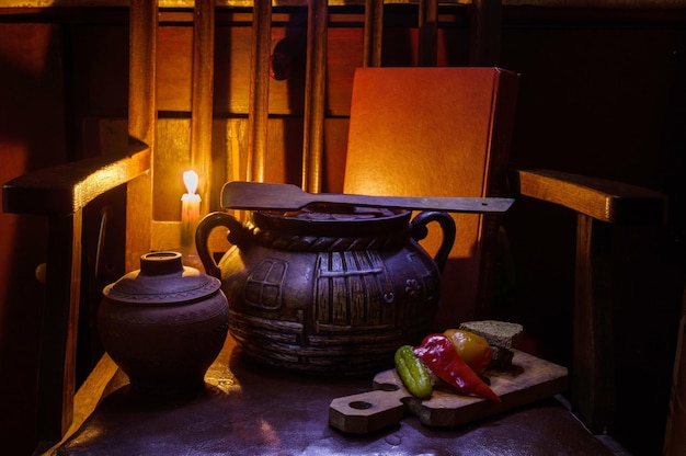 Nourriture et bougie nature morte Poterie ancienne et une bougie Nature morte dans une clé discrète Bougie allumée et nourriture sur la table Nourriture dans des pots en argile