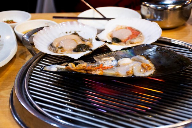 Nourriture gastronomique grillée fruits de mer rôtis et coquille frite brûlée pour les voyageurs coréens visiter et goûter manger des boissons cuisine dans un restaurant local au Hueundae Street Food Market à Busan en Corée du Sud