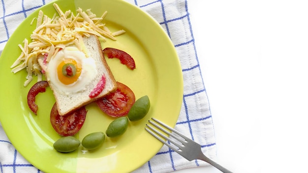 Nourriture pour enfants. Oeuf brouillé sur du pain grillé sous forme de monstre drôle avec du fromage et des olives d'un plat