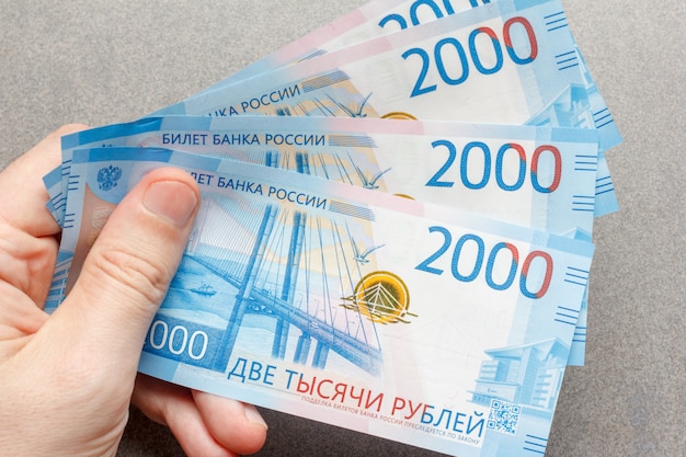 Nouveaux billets russes libellés en 2000 roubles en gros plan main masculine