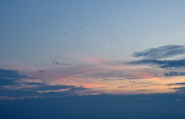 Nouvelle lune et beau coucher de soleil. Fond de nature dramatique.