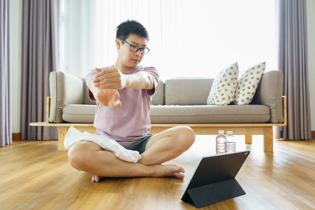 Nouvelle norme. Homme asiatique s'entraînant à la maison