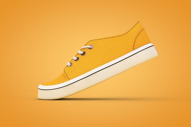 Nouvelles baskets en denim orange sans marque sur fond orange. Rendu 3D